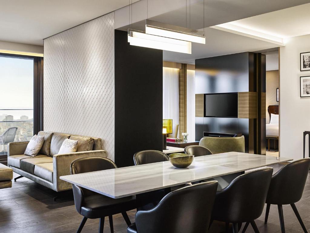 a dining room with a table and chairs at Fairmont Quasar Istanbul Hotel in Istanbul