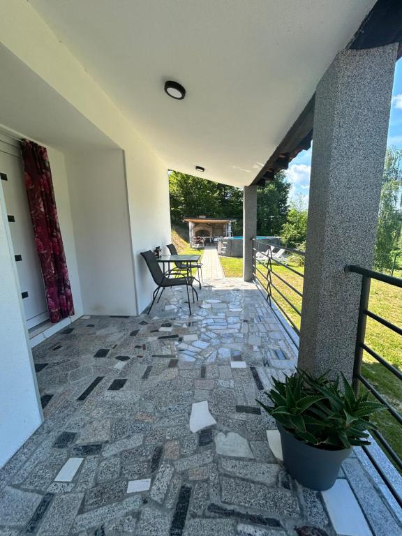 a screened in porch with a bench on a patio at Vila Fina in Laktaši