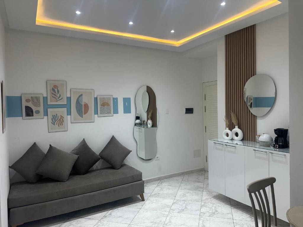 a living room with a couch and a kitchen at Blue'ming Sousse in Sousse