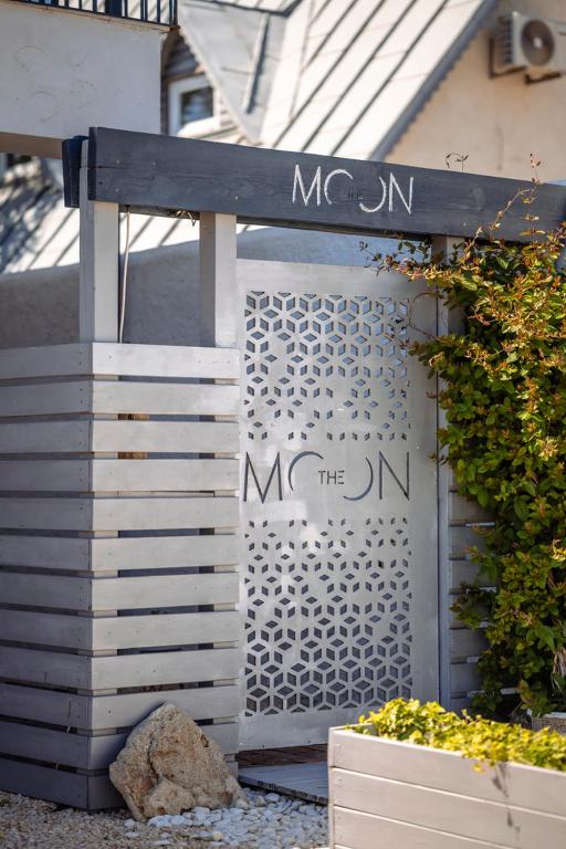 a metal gate with the name of the dmn at The Moon Vama Veche in Vama Veche