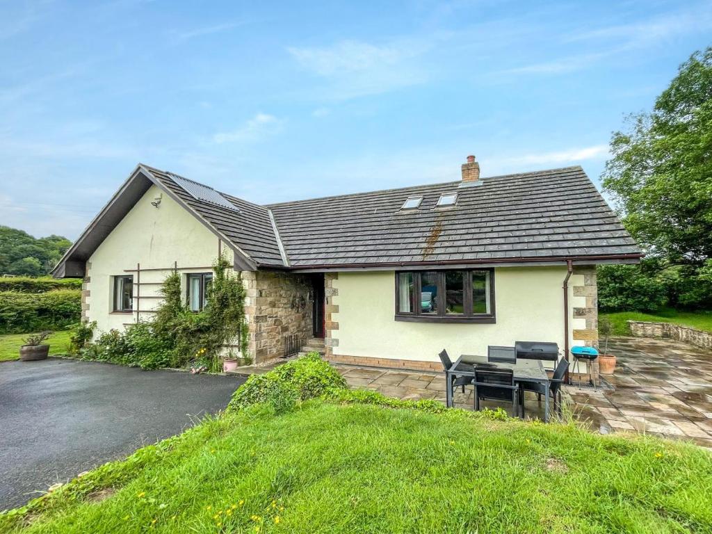 a white house with a table in front of it at 4 Bed in Morpeth oc-86132 in Warkworth