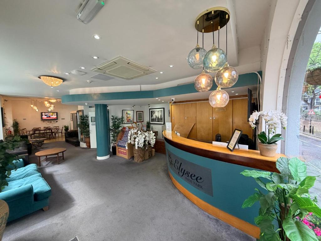 a lobby of a store with a table and chairs at Elysee Hyde Park in London