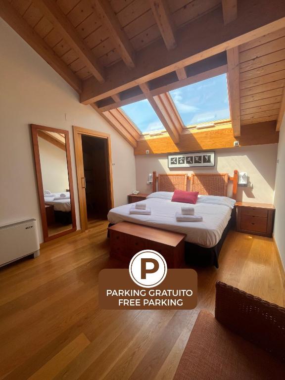 a bedroom with a bed and a large window at Hotel Casa Azcona in Zizur Mayor