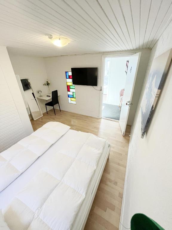 a bedroom with a large white bed in a room at Central Large Double Room with free parking in Aalborg