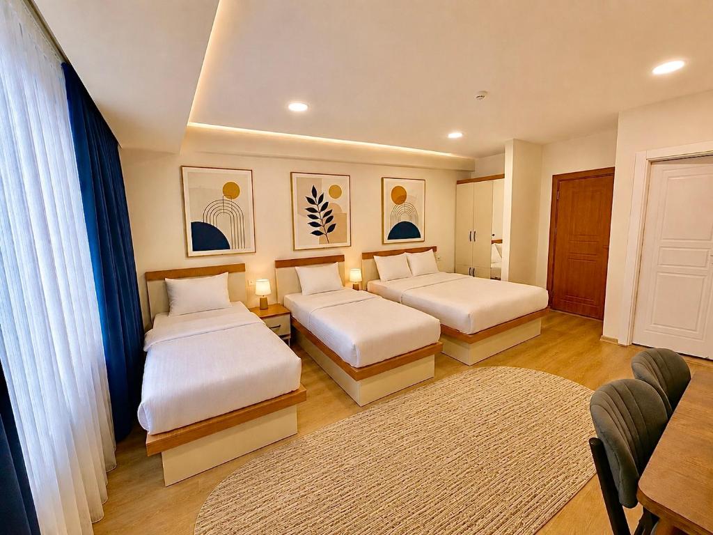 a hotel room with two beds and a table at ISTANBUL STAY Boutıque Hotel in Istanbul