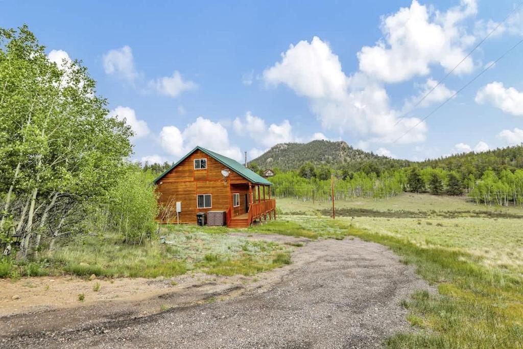 a wooden cabin in the middle of a field at Cozy Deer Valley Cabin- Views Fireplace & Deck in Jefferson