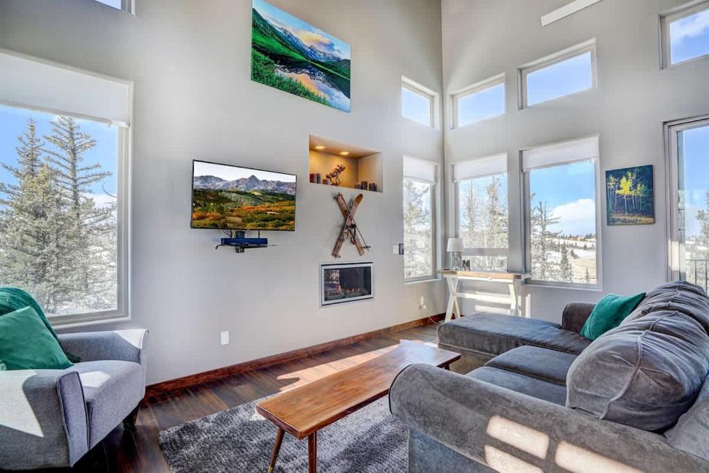 a living room with two couches and windows at Mountain Escape with Spectacular Views in Jefferson
