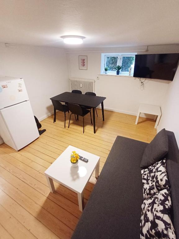 a living room with a couch and a table at Central apartment in Aalborg close to Hospital in Aalborg