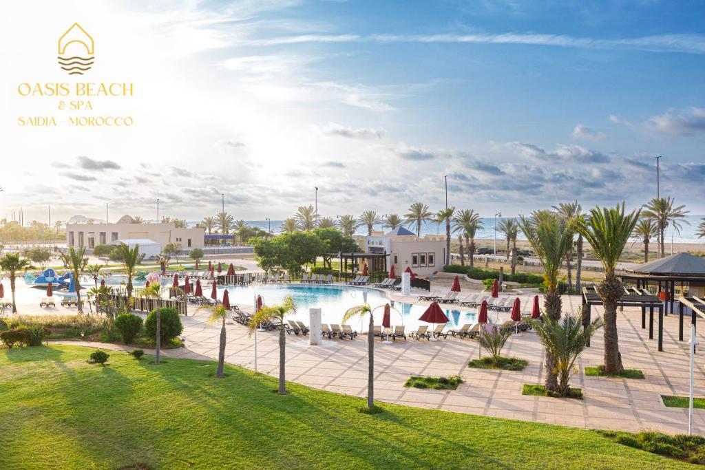 a resort with a swimming pool and palm trees at Oasis Beach & Spa - Blue Pearl in Saïdia