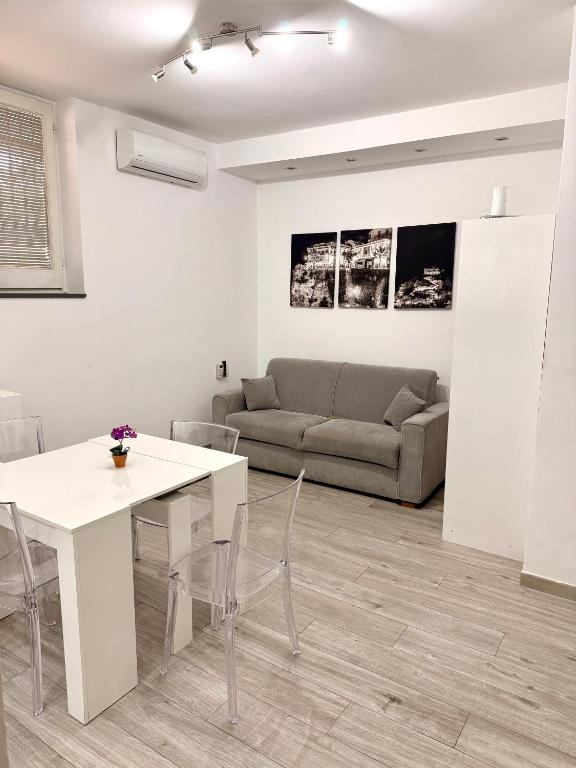 a living room with a white table and a couch at Casa Valentina in Tropea