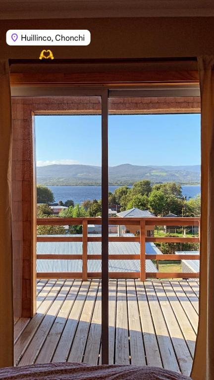 a view from the window of a deck with a view at Cabañas Lago Huillinco in Chonchi