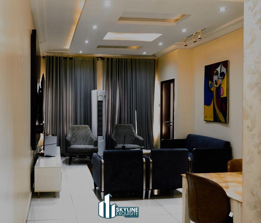 a waiting room with chairs and a table at Skyline Exquisite in Araromi