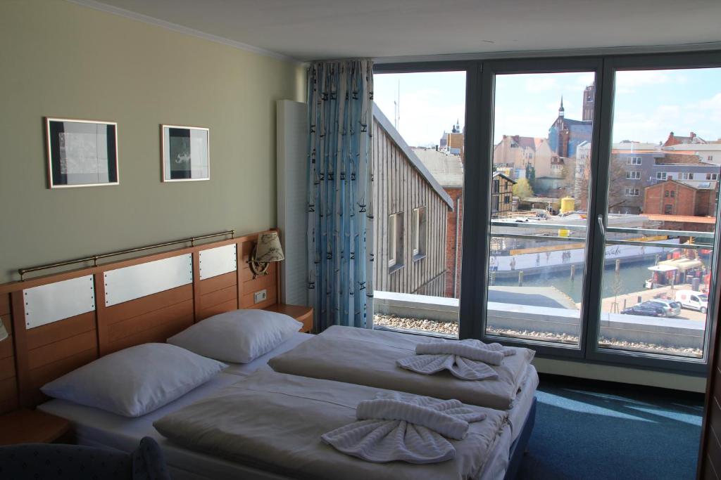Postel nebo postele na pokoji v ubytování Hiddenseer Hotel