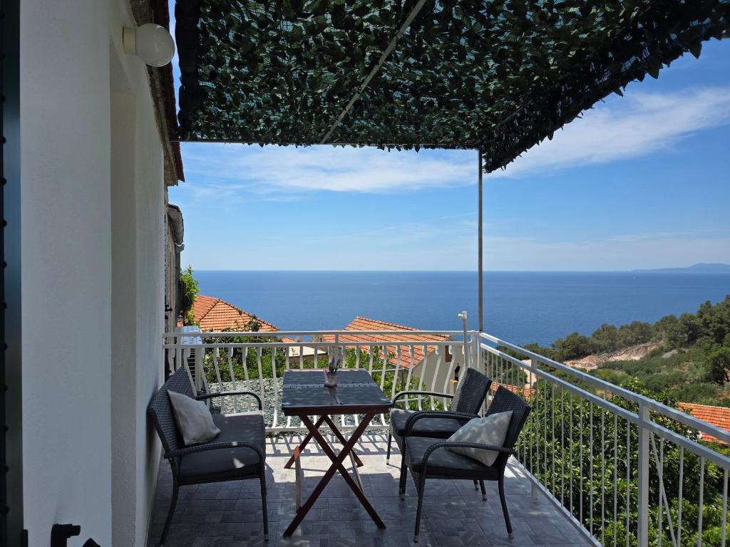a patio with chairs and a table on a balcony at Apartment Zagalo in Sveta Nedelja