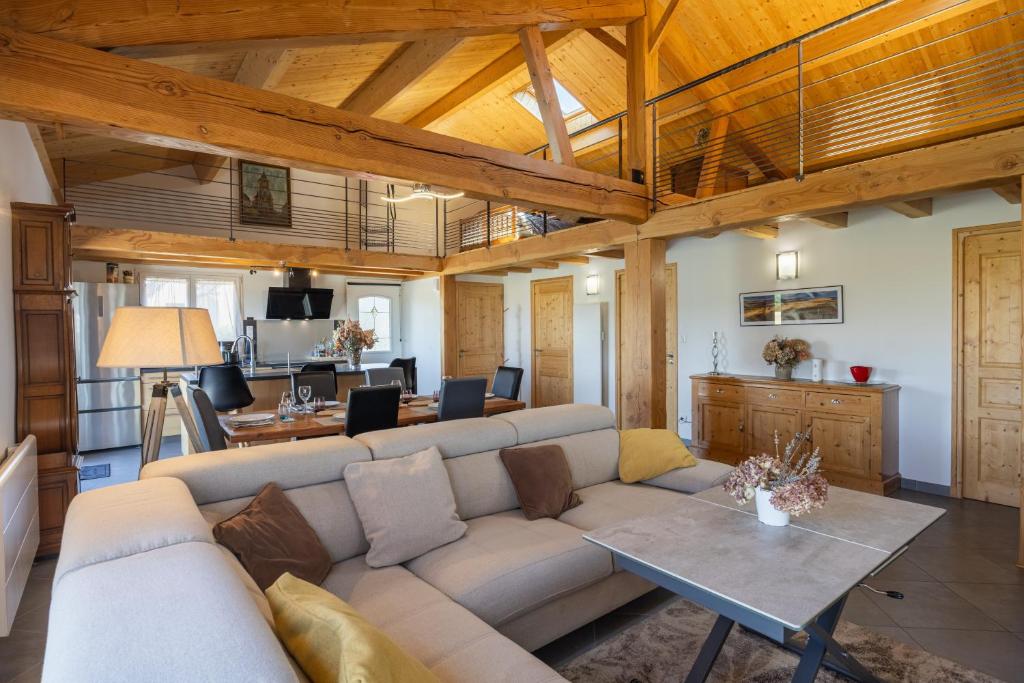 a living room with a couch and a table at Maison Chalet in Le Nayrac