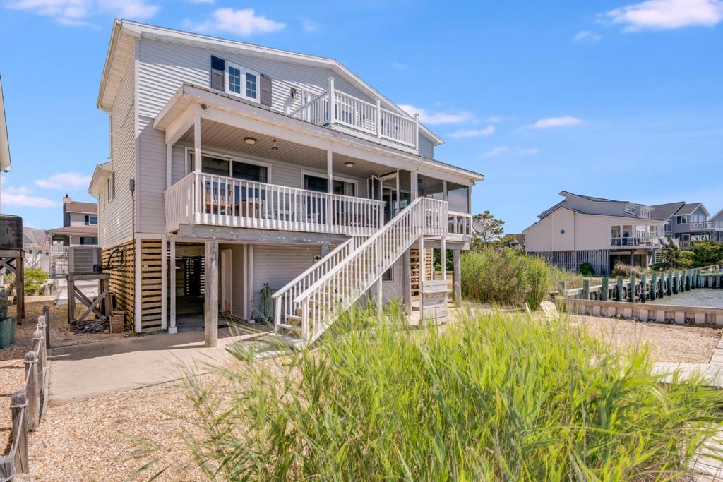 a house on the beach with stairs leading up to it at Serenity Now in Greenbackville