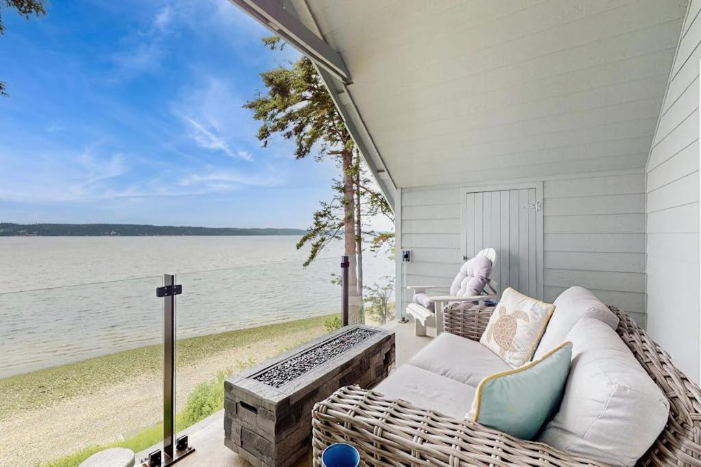 a porch with a couch and a view of the ocean at Breezy Point Retreat in Saratoga Shores
