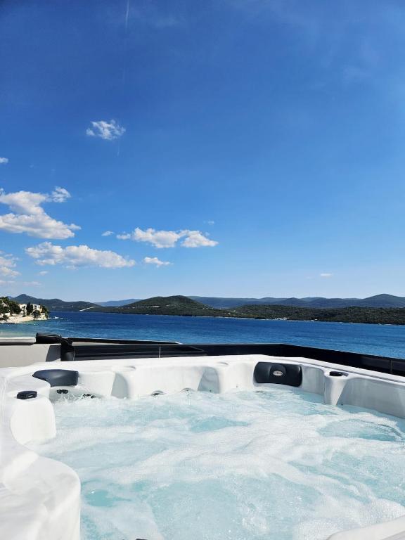 a jacuzzi tub with a view of the water at Villa Truman Klek in Klek