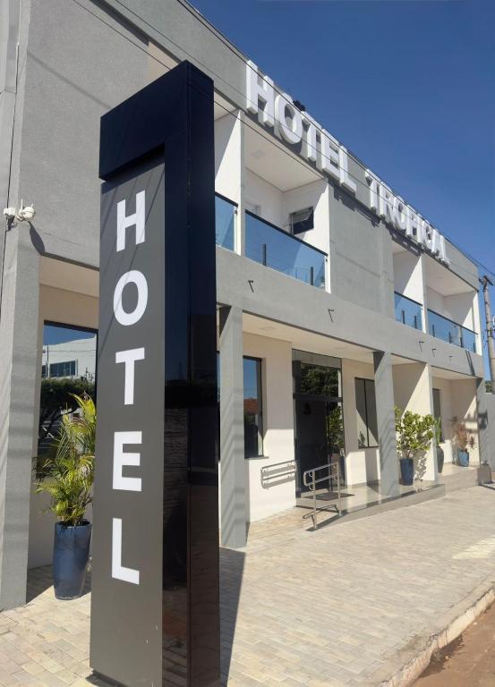 a building with a hotel sign in front of it at Hotel Tropical in Aquidauana