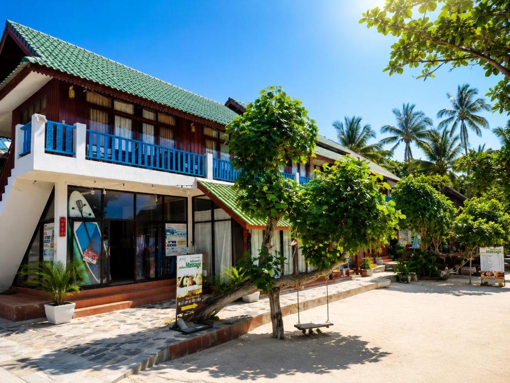 a building with a tree in front of it at Nami by Secret Place in Mae Haad