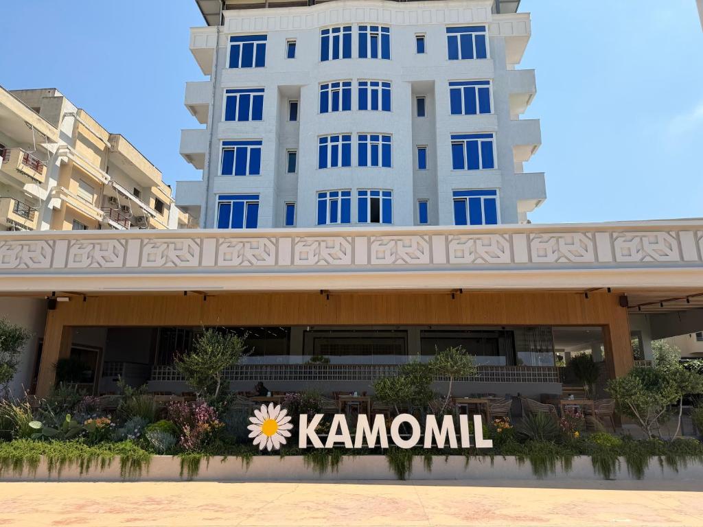 a sign in front of a building at Hotel Kamomil in Durrës