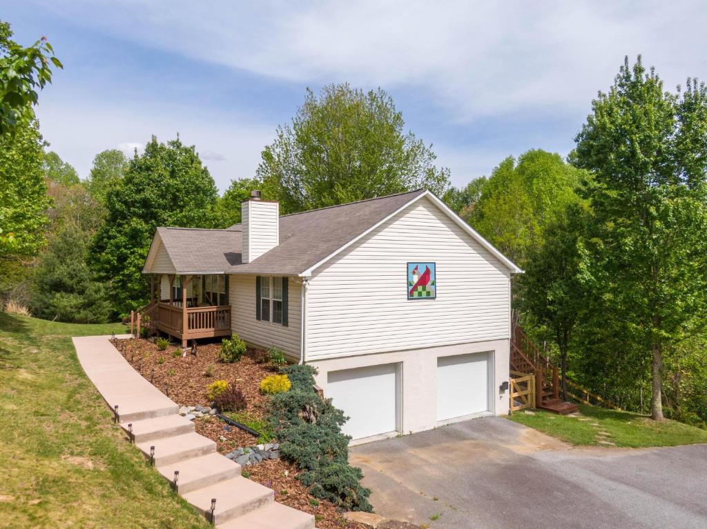 a white house with a garage at Our Happy Nest in Boone