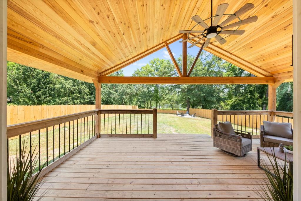 a wooden pavilion with a ceiling fan on a deck at Lakeview Retreat - Family-Friendly - Near Downtown in Macon