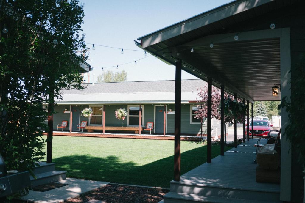 a covered porch of a house with a yard at Pinedale Cozy Cabins in Pinedale