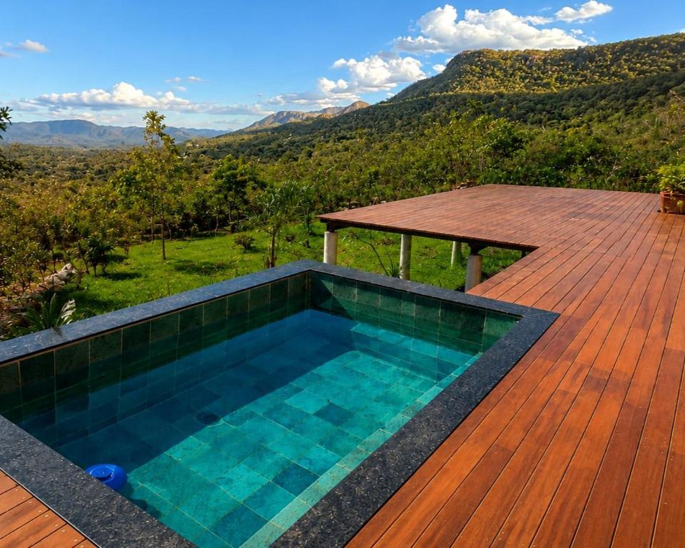 a swimming pool on a wooden deck with a picnic table at Casa Mirante 360 in Cavalcante