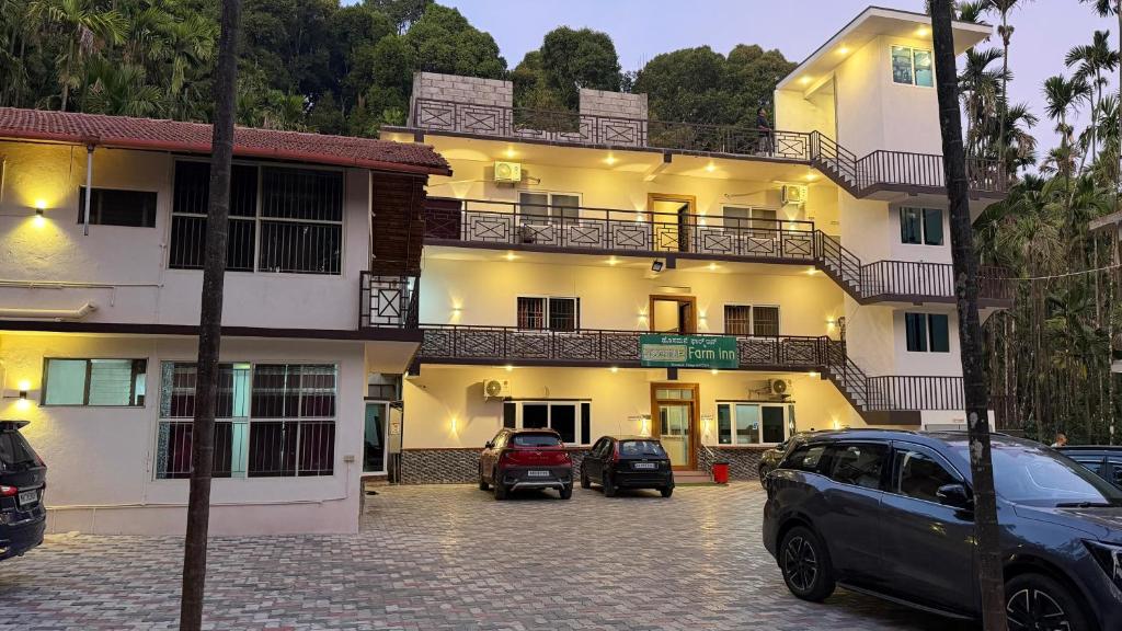 a building with cars parked in front of it at Hosamane Farm Inn in Sringeri