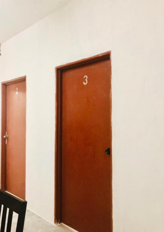 a brown door in a room with a wall at Rumah Teduh Desa in Kuala Rompin