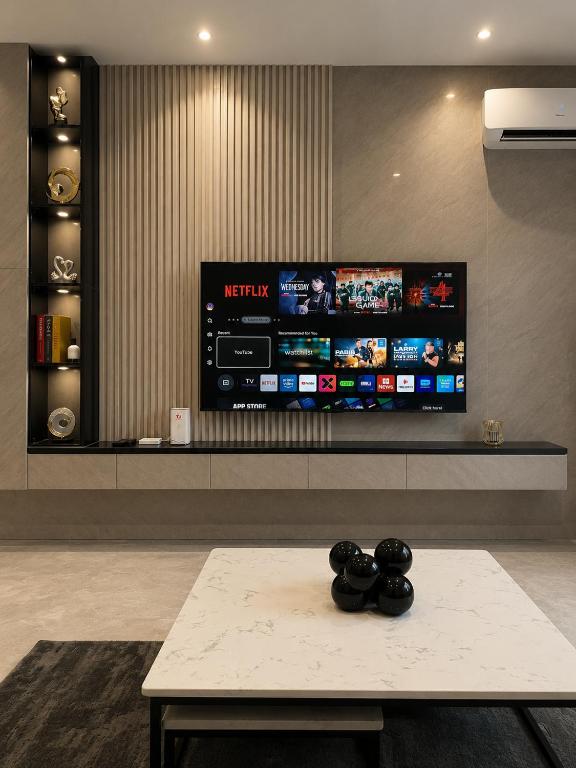 a living room with a tv and a table at Ileero Homes The Beachfront in Lekki