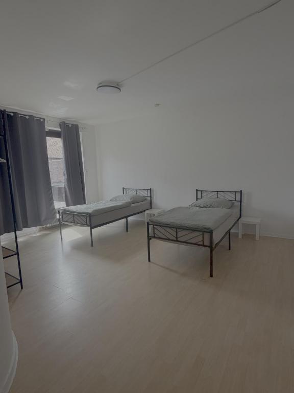 a hospital room with two beds and a window at Apartment Wesel in Wesel