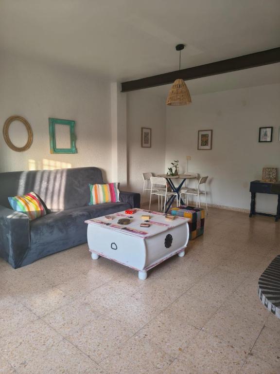 a living room with a couch and a coffee table at Eco- Refugio Centenario in Sagunto
