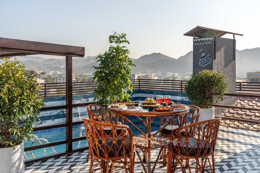 a table and chairs on a balcony with a view at Mangal Residency in Bedla