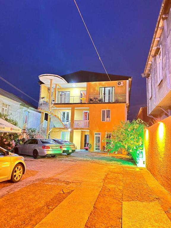 a building with cars parked in front of it at Blue wave in Itʼkhvisi