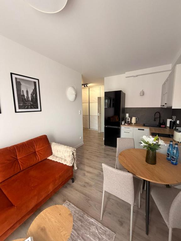 a living room with a couch and a table at Apartament 15 in Lębork