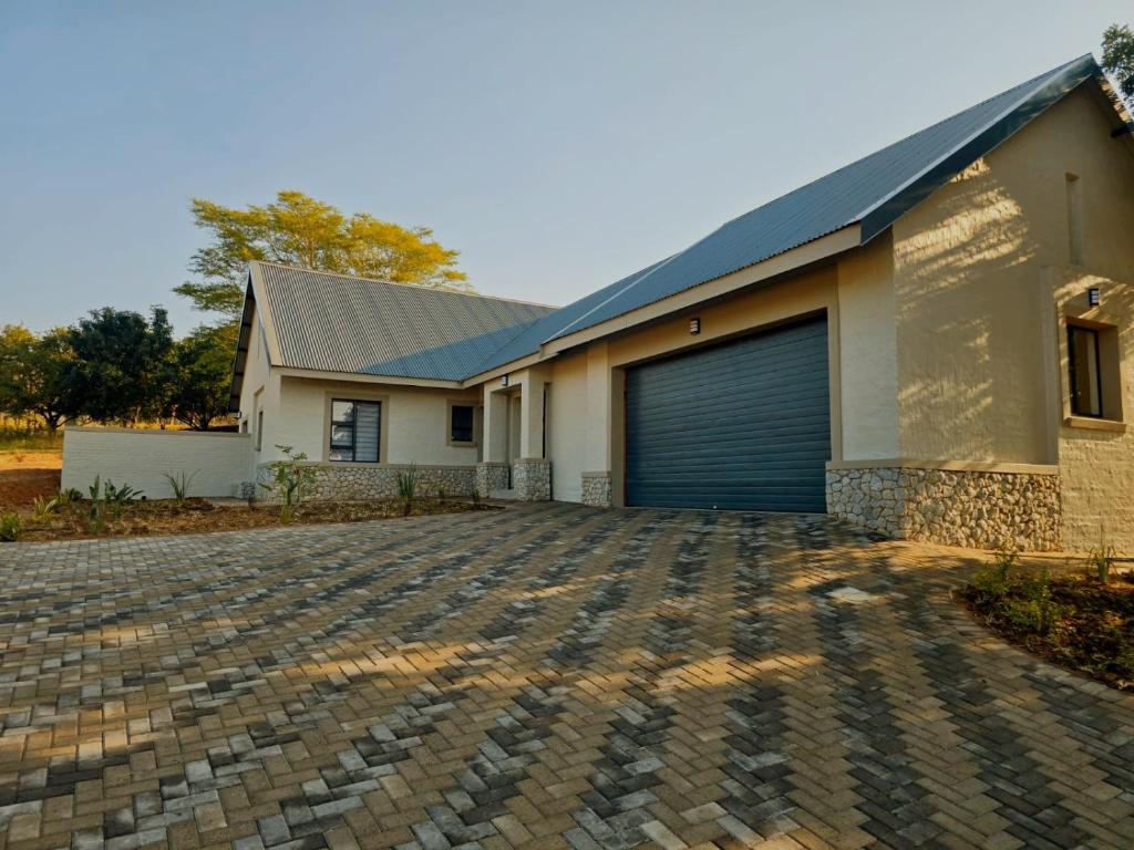 a house with a garage and a driveway at Solana Villa in Hazyview