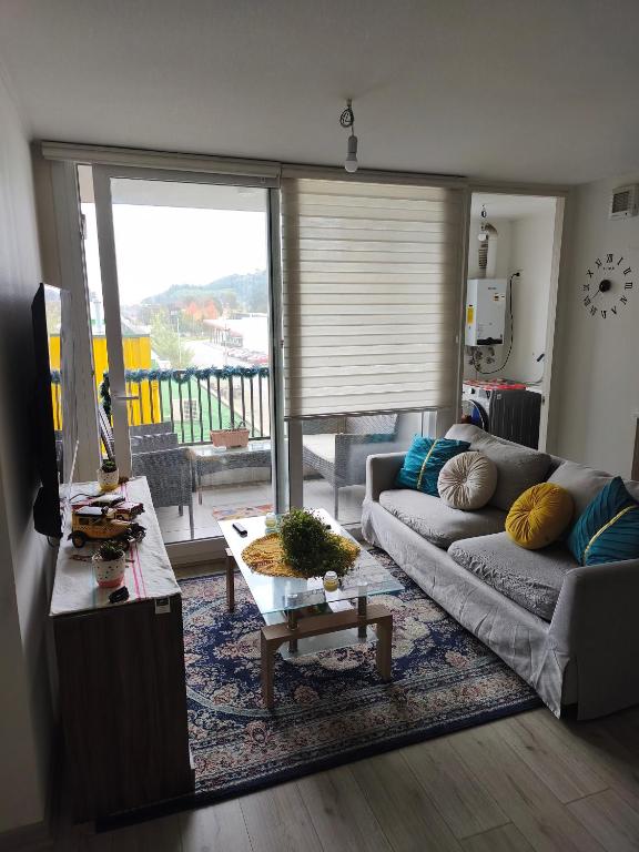 a living room with a couch and a table at Departamento Temuco in Temuco