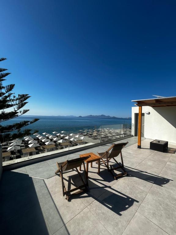 a patio with a table and chairs on a roof at Starlight Ocean View in Kardamaina