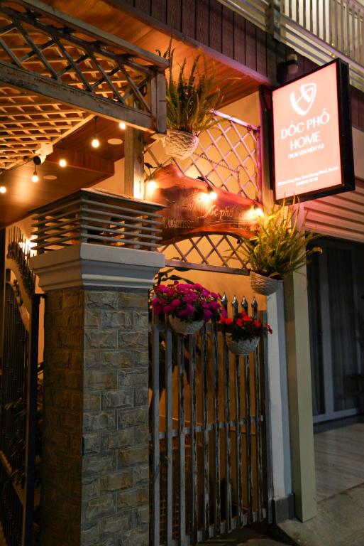 a restaurant with plants on the front of a fence at Dốc Phố Home - Dalat Homestay in Xuan An