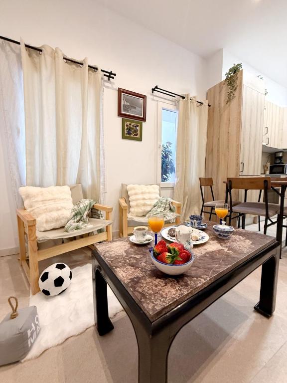 a living room with a table with a bowl of fruit on it at Posada de María Casa Cori 5 in Talavera de la Reina
