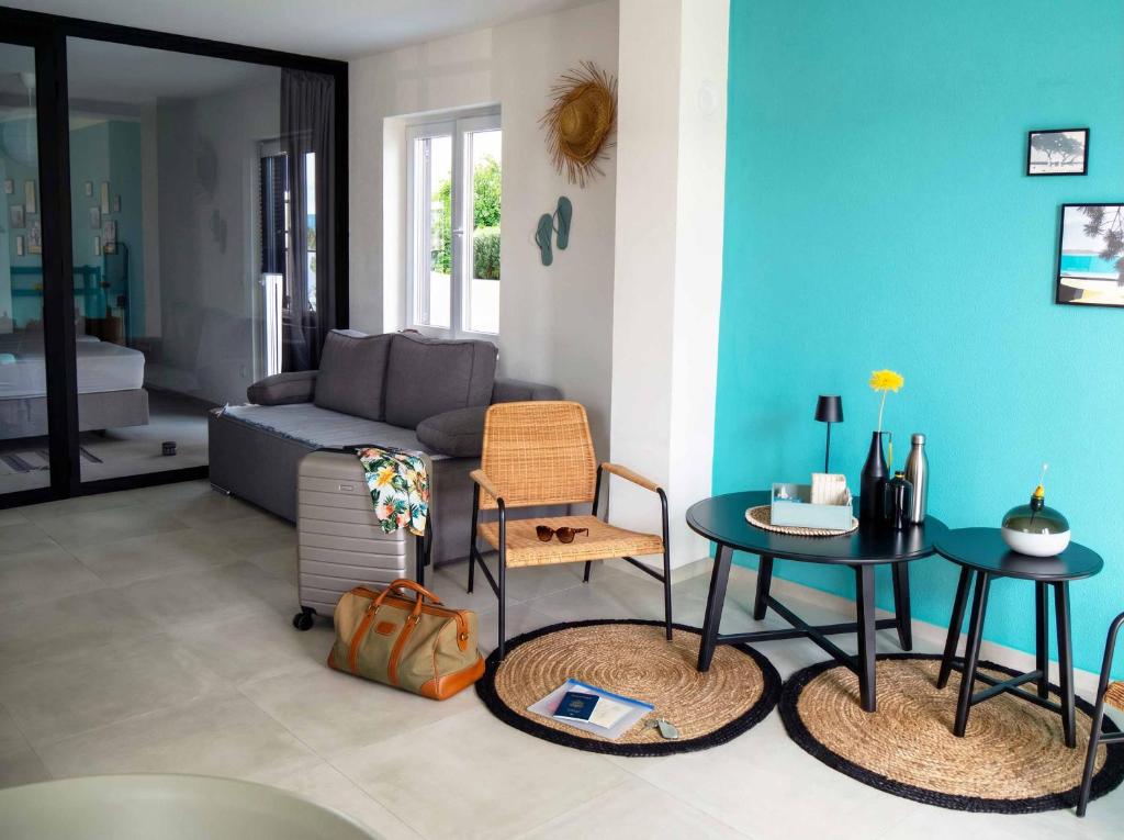 a living room with a couch and a table and chairs at holiday by the sea in Marusici 
