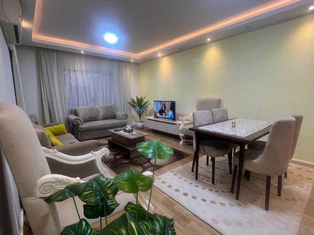 a living room with a table and chairs at SUNSKY Apartment Hotel in New cairo