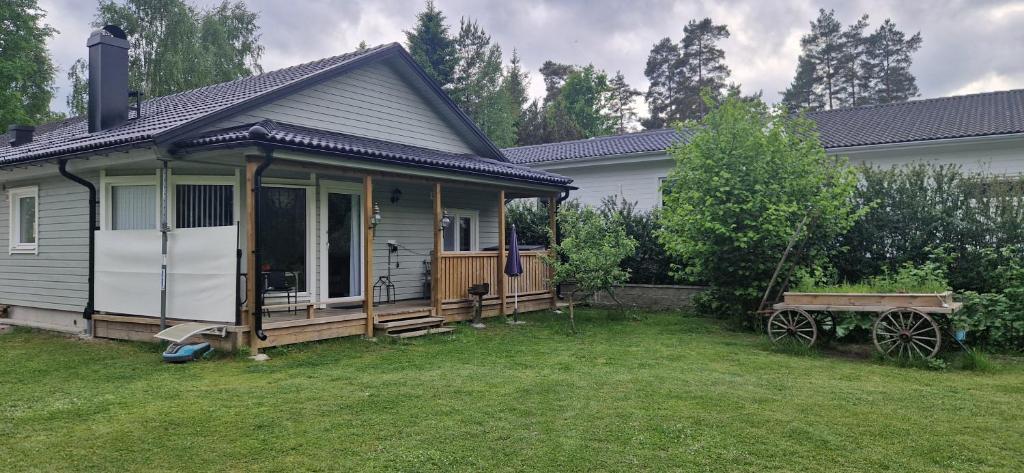 a small house with a porch and a yard at Sjöviksvilla Sjöviksvägen in Växjö