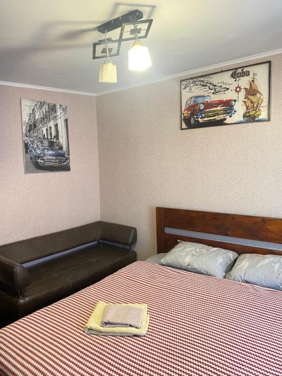 a bedroom with a bed with a napkin on it at AURa in Zhytomyr