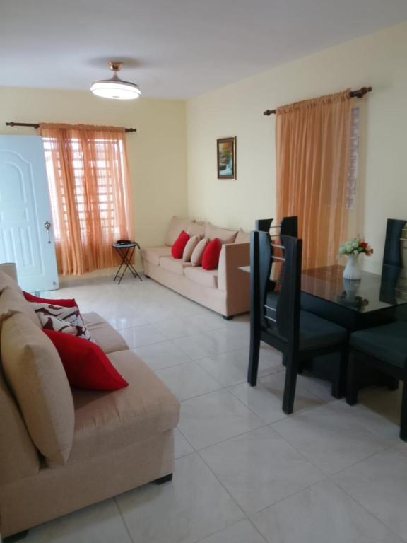 a living room with a couch and a table at house on the hill in Nagua