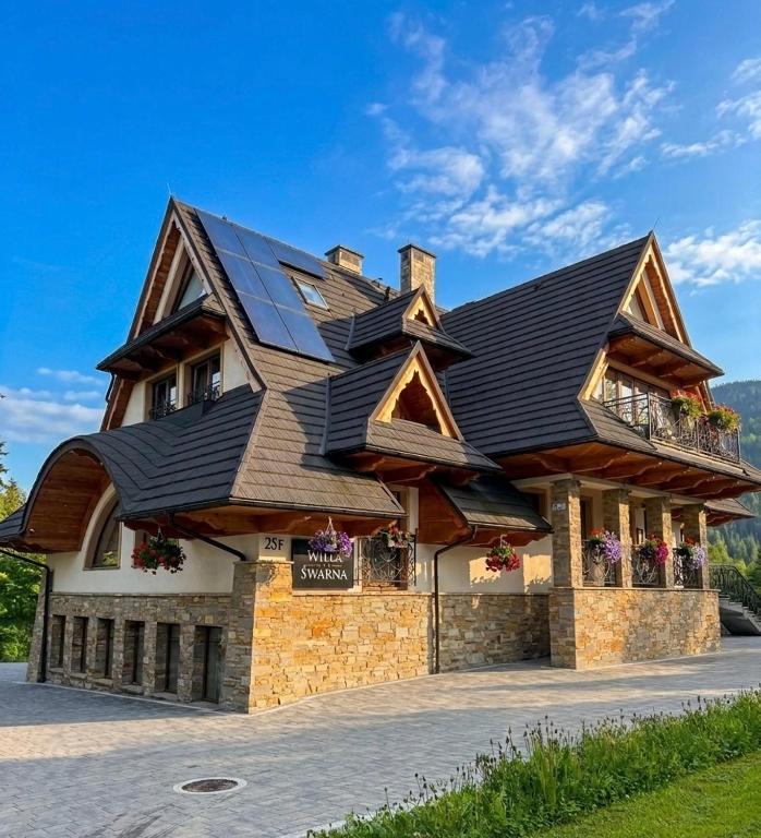a house with solar panels on top of it at Willa Śwarna I in Zakopane