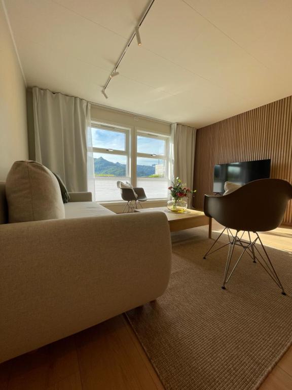 a living room with a couch and a table at City Svolvær Apartment in Svolvær