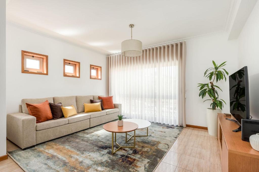 a living room with a couch and a table at Cinfães Centro Stay in Cinfães